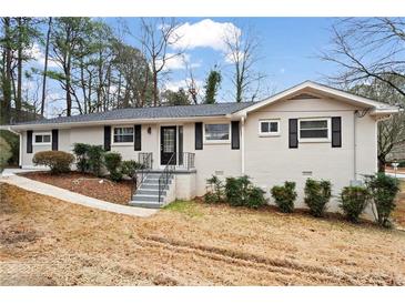 Charming single-story home with a painted brick exterior, neat landscaping, and a welcoming front entrance at 2771 Ridge Park Dr, Tucker, GA 30084
