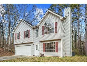 Two-story house with attached garage and red shutters at 6207 Willowbrook Dr, Riverdale, GA 30296