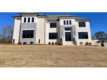 Two-story house with stone accents and a large front yard at 3072 Reserve Ct Sw, Conyers, GA 30094