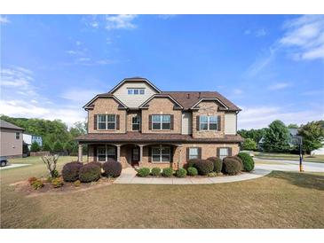 Two story brick home with landscaped yard and large driveway at 4302 Maclaren Ct, Powder Springs, GA 30127