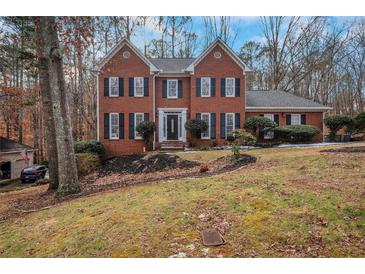 Brick two-story house with a landscaped yard at 2530 Ashbourne Dr, Lawrenceville, GA 30043