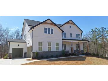 Charming two-story home with white siding, a covered porch, and an attached two-car garage at 4525 Aiden Way, Cumming, GA 30041