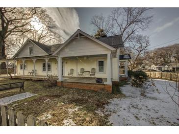 Charming yellow house with a wrap-around porch and fenced yard at 410 Sycamore Se St, Marietta, GA 30060