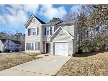 Two-story house with a white garage door and stone accents at 4229 Reeshemah St, Union City, GA 30349