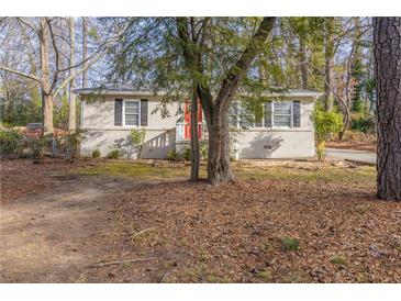 Ranch style home with mature trees and a red front door at 667 Steve Sw Dr, Atlanta, GA 30315