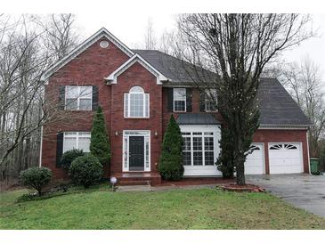 Brick two-story house with attached garage and landscaped lawn at 1886 Clay Sw Dr, Marietta, GA 30064