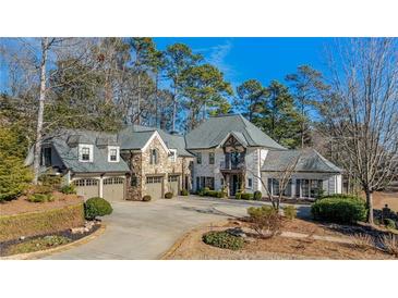 Stunning stone house with a large driveway and mature trees at 571 Glen Eagles Se Cir, Marietta, GA 30067