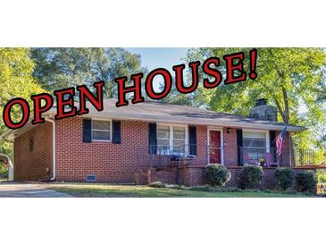 Charming brick home featuring a well-maintained front yard and inviting curb appeal at 156 Main St, Lilburn, GA 30047