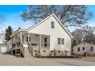 White house with a large porch and driveway at 1097 Dell Se Ave, Smyrna, GA 30080