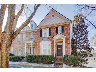 Brick front townhouse with landscaping and a charming porch at 1653 Perserverence Hill Nw Cir # 10, Kennesaw, GA 30152