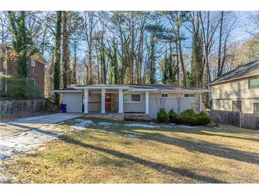 Ranch style home with a red door and covered porch at 1883 La Mesa Ln, Decatur, GA 30032