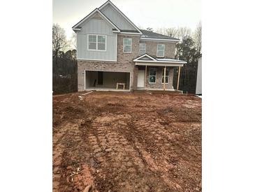 Two-story house with attached garage and unfinished yard at 566 Abbott Se Ct, Atlanta, GA 30354