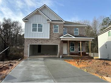 Two-story brick home with a large driveway and attached garage at 566 Abbott Se Ct, Atlanta, GA 30354