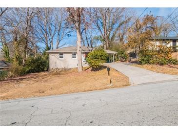 Ranch style home with a red door and carport at 3018 Meadowview Se Dr, Atlanta, GA 30316