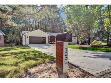 Ranch home with modern updates, landscaped yard, and long driveway at 350 Jayne Ellen Way, Alpharetta, GA 30009