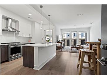 Modern kitchen with stainless steel appliances and an island at 775 Juniper Ne St # 413, Atlanta, GA 30308