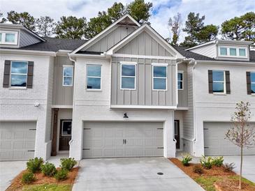 Modern two-story townhome with gray siding and brick accents at 5445 Rock Place Ct # 39, Norcross, GA 30093