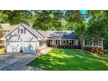 Ranch style home with attached two-car garage and landscaped lawn at 4692 Yeager Rd, Douglasville, GA 30135