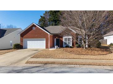 Brick ranch home with attached garage and landscaped yard at 175 Robin Ct, Fayetteville, GA 30215