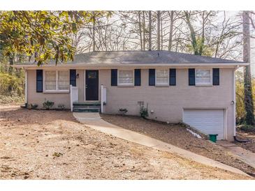 Ranch style home with gray brick exterior, black shutters, and attached garage at 4083 Thetford Ct, Decatur, GA 30035