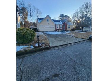 Ranch style home with attached garage and landscaped yard at 2210 Burdett Ridge, Atlanta, GA 30349