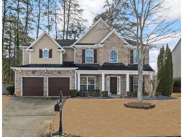 Two-story brick house with a two-car garage and manicured lawn at 679 Crosswinds Cir, Marietta, GA 30008