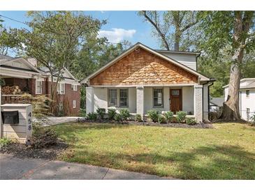 Charming craftsman bungalow with white brick, wood accents, and a manicured lawn at 458 Holly Nw St, Atlanta, GA 30318