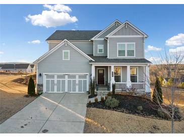 Two-story house with gray siding, three-car garage, and front porch at 4130 Grandview Vista St, Cumming, GA 30028