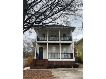 Charming two-story home boasts double porches, a brick foundation, and freshly landscaped surroundings at 59 Stafford Nw St, Atlanta, GA 30314