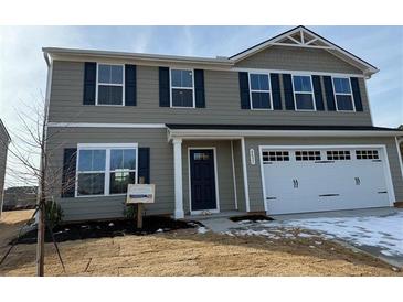 Two-story house with gray siding, a two-car garage, and a welcoming front porch at , Stone Mountain, GA 30087