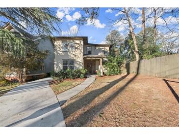 Two-story house with driveway and walkway, surrounded by trees and a fence at 1159 Morley Se Ave, Atlanta, GA 30312