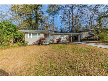 Ranch style home with carport and landscaped yard at 3110 Mcafee Rd, Decatur, GA 30032