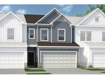 Two-story townhome with gray siding, brown roof, and two-car garage at 1180 Chastain Dr # 9, Sugar Hill, GA 30518