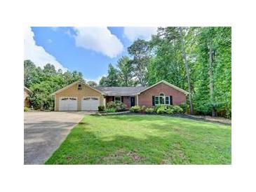 Brick ranch house with attached two-car garage and landscaped lawn at 2842 Cardinal Lake Dr, Duluth, GA 30096