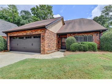 Brick ranch home with 2-car garage, lush lawn, and mature shrubs at 6 Westchester Sq, Decatur, GA 30030