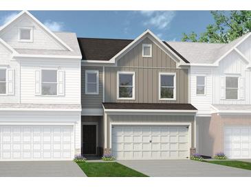 Two-story townhome with neutral siding and a brown roof at 1182 Chastain Dr # 8, Sugar Hill, GA 30518