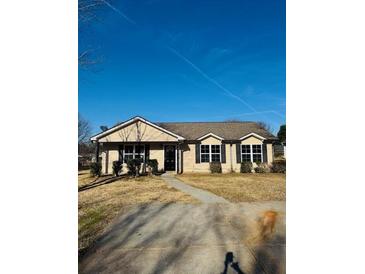 Ranch style home with a paved driveway and well-maintained lawn at 415 Dove Ln, Social Circle, GA 30025