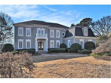 Stunning two-story home with a classic facade and manicured lawn at 4720 Cliffside Ct, Marietta, GA 30067