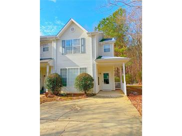 Charming two-story townhome with covered porch and landscaping at 6691 Sunset Hills Blvd, Rex, GA 30273