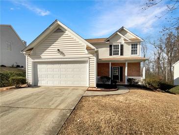 Two-story house with attached garage and manicured lawn at 1535 Valley Club Dr, Lawrenceville, GA 30044