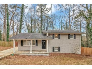 Charming, single-story house with a covered front porch, offering a welcoming entrance and great curb appeal at 1963 Shannon Ridge Ct, Decatur, GA 30032