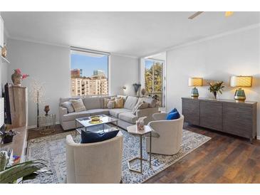 Spacious living room with hardwood floors, large windows, and city views at 130 26Th Nw St # 804, Atlanta, GA 30309