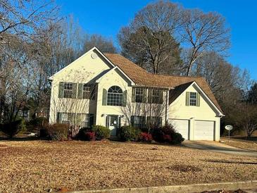 Two-story house with a beige exterior, brown roof, and attached two-car garage at 4010 Peachtree Farms Rd, Rex, GA 30273