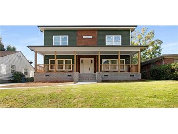 Two-story house with green and brown siding, a large front porch, and a well-manicured lawn at 1432 Mims Sw St, Atlanta, GA 30314