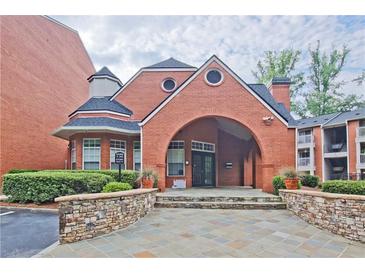 A handsome red brick building with a charming archway entrance creates a welcoming sense of arrival at 3066 Chastain Park Ne Ct, Atlanta, GA 30342