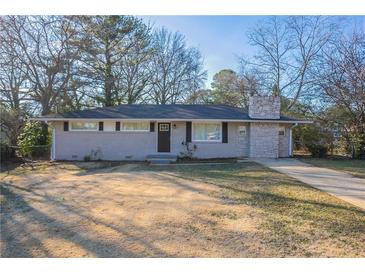 Newly renovated ranch home with stone accents and a well-manicured lawn at 3854 Brookcrest Cir, Decatur, GA 30032