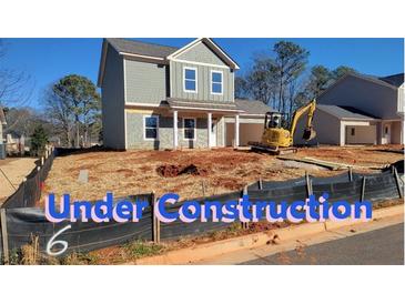 New construction home exterior; gray siding, two-car garage, under construction at 358 Forkview Dr, Lawrenceville, GA 30044