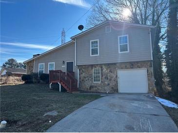 Two-story house with attached garage and wooden deck at 3690 Darrah Sw Way, Atlanta, GA 30331