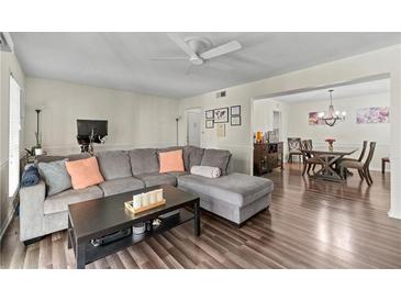 Spacious living room featuring hardwood floors and a comfortable sectional sofa at 6851 Roswell Rd # F35, Atlanta, GA 30328