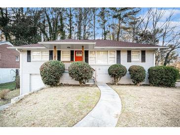 Charming ranch home with red door and well-manicured lawn at 226 Collum Nw St, Atlanta, GA 30314